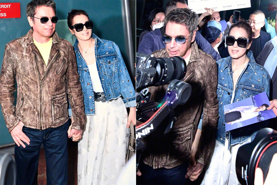 Vợ chồng Củng Lợi ở sân bay. Ảnh: Sina