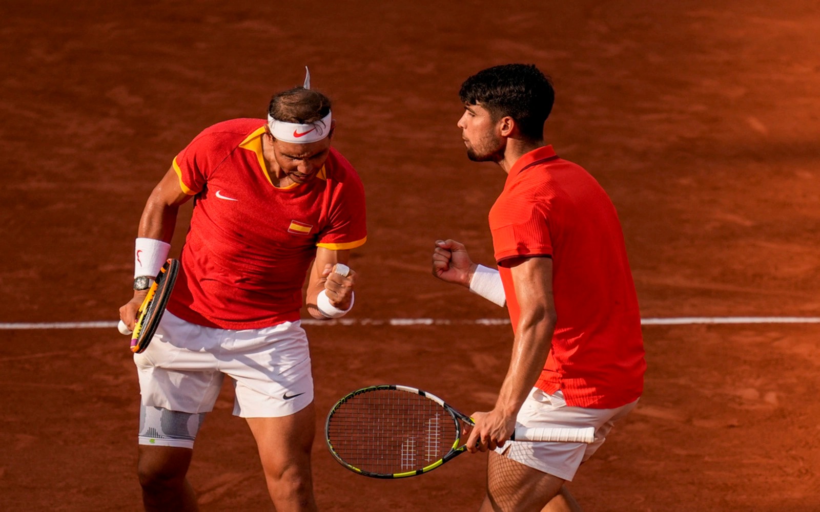 Nadal (trái) và Alcaraz mừng một điểm thắng trong trận gặp Griekspoor và Koolhof ở vòng hai đôi nam Olympic, trên sân Suzanne Lenglen, Paris hôm 30/7. Ảnh: Reuters